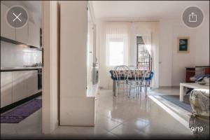 a kitchen and living room with a table and chairs at Appartamento Serapo in Gaeta