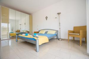 a bedroom with a bed and a chair in it at Villa Luca in Pastida +40 photos