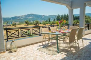 a patio with a table and chairs on a balcony at Villa Luca in Pastida