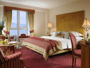 a hotel room with a bed and a large window at Galway Bay Hotel Conference & Leisure Centre in Galway