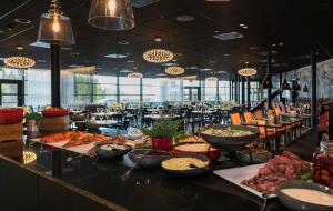 a buffet line with food on a table in a restaurant at Thon Hotel Oslo Airport in Gardermoen