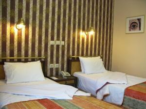 Posteľ alebo postele v izbe v ubytovaní Olympos Hotel