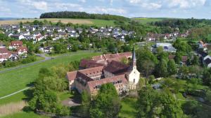 an aerial view of a small town with a church at Tagungszentrum Schmerlenbach in Hösbach