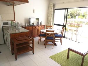 a kitchen with a table and some chairs and a table at Torre da Rocha in Portimão