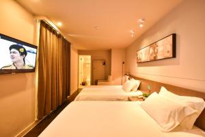 Postelja oz. postelje v sobi nastanitve Jinjiang Inn Haikou Binhai Avenue Qilou Old Street