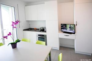 a kitchen with a table and a microwave at Residence Acquasuite in Martinsicuro