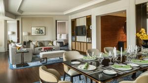 a room with a dining table and a living room at Four Seasons Hotel Macao, Cotai Strip in Macau