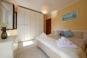 a bedroom with two beds with towels on them at Petalo Bianco 100m from lake - Happy Rentals in Baveno