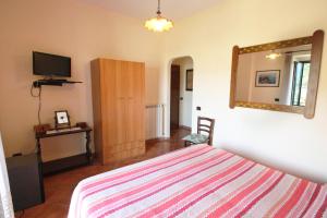 a bedroom with a bed and a television at Casarufolo Paradise in Sorrento
