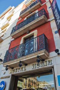 a building with a sign for a hospital morgue at Hostal Noria in Tarragona