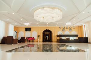 a large lobby with a chandelier in a building at Bek Khiva Hotel in Khiva