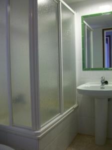a bathroom with a shower and a sink at Apartamentos Mitus in Canet de Mar