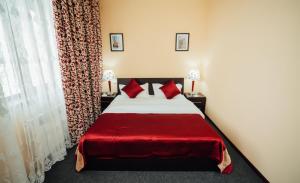 a bedroom with a large bed with red pillows at Bek Khiva Hotel in Khiva +34 photos