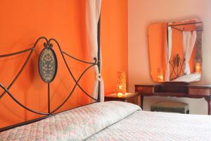 a bed sitting in a bedroom next to a wall at Casarufolo Paradise in Sorrento