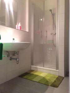 a bathroom with a sink and a shower at Old Citycenter Appartment in Graz