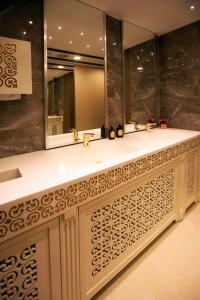 a bathroom with two sinks and a large mirror at The Escape Hotel in Agva