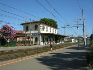 a person standing on a platform at a train station at A pochi passi dal mare in Torre del Lago Puccini