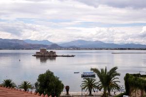 a large body of water with a boat in it at Gambello Luxury Rooms in Nafplio