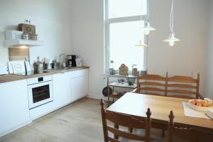a kitchen with a wooden table and a dining room at Die schöne Auguste in Oldenburg