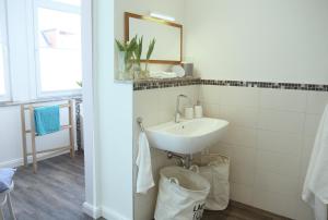 a bathroom with a sink and a mirror at Die schöne Auguste in Oldenburg +23 photos