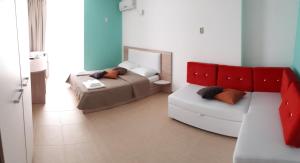 a living room with a bed and a couch at Guest House Bereg in Anapa