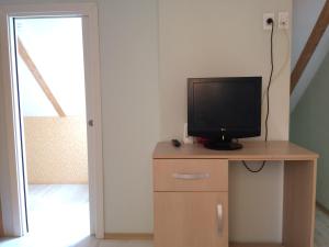 a television sitting on top of a wooden cabinet at Casa Salcia Oituz in Oituz