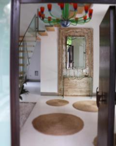 a room with a hallway with a mirror and stairs at la casa de las pergolas in Seville