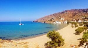 a view of a beach with a boat in the water at panormos studio in Panormos