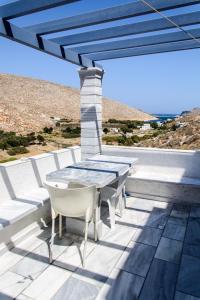 a table and chairs on a patio with a view at Theodora in Panormos +50 photos