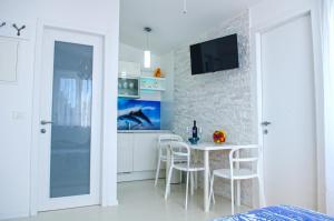 a kitchen with a table and chairs in a room at Villa Mmm in Vantačići