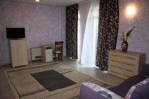 Un televizor și/sau centru de divertisment la Hotel Hyperion