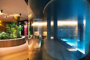 a room with a swimming pool in a building at Akelarre - Relais & Châteaux in Donostia-San Sebastián
