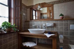 a bathroom with a sink and a mirror at Halasi Pince Panzió in Villány