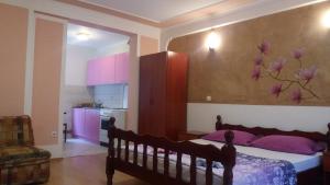 a bedroom with a bed with a flower on the wall at Guest House Stankovic in Soko Banja