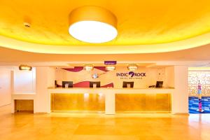 a lobby of a mcdonalds restaurant with a yellow ceiling at Indico Rock Hotel Mallorca - Adults Only in Playa de Palma