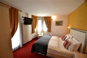Posteľ alebo postele v izbe v ubytovaní Hotel Piccolo Tibet