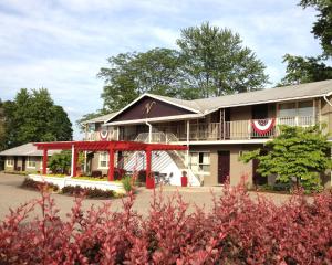 a large building with a red roof at Vinehurst Inn & Suites in Hammondsport