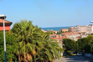 a view of a city with palm trees and buildings at casa letizia in Porto Recanati