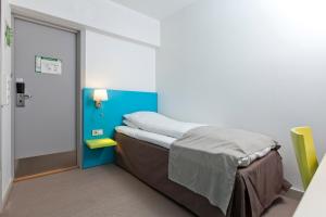 Postel nebo postele na pokoji v ubytování MediInn Hotel Oslo