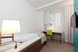 Postel nebo postele na pokoji v ubytování MediInn Hotel Oslo