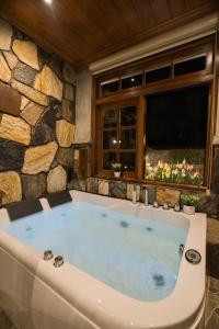 a large bath tub in a room with a window at La Grande Villa in Nuwara Eliya