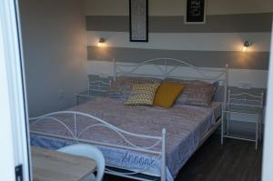 a bedroom with a bed with pillows on it at Apartments Valentino in Rab