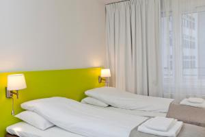 Postel nebo postele na pokoji v ubytování MediInn Hotel Oslo