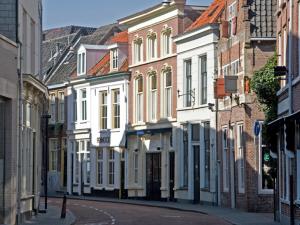 an empty street in a city with buildings at The Guest Apartments in Den Bosch