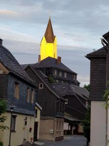 a church steeple with a cross on top of it at Pension Antik in Bad Lobenstein