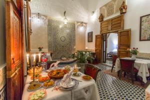 a table with food on it in a room at Dar Fes Medina Ziat in Fez