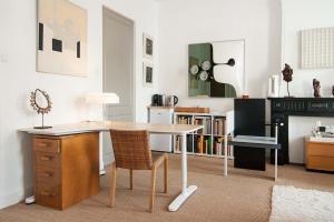 a kitchen with a desk and a table with a chair at The Market Retreat in Amsterdam