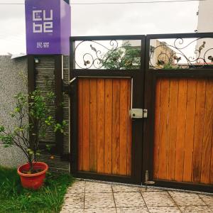 a pair of wooden doors in front of a building at 旅人空間The Cube Inn Homestay本民宿未與Agod a合作 We are not partnered with Agod a in Dongshan +12 photos
