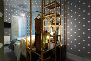 a bedroom with a bed with polka dots on the wall at Intervallo Boutique Hotel in Ragusa