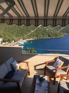 a living room with a view of a body of water at Apartments Ladesta in Lastovo